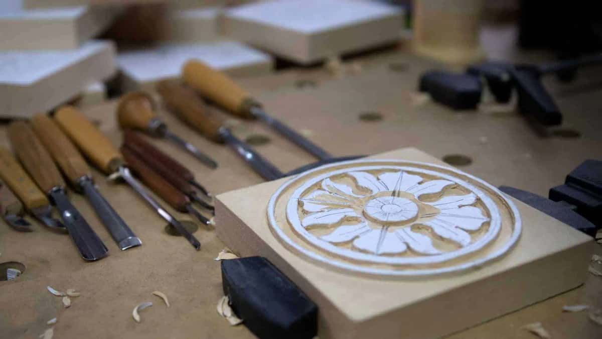 Half finished rosette carving beside a row of sharp gouges