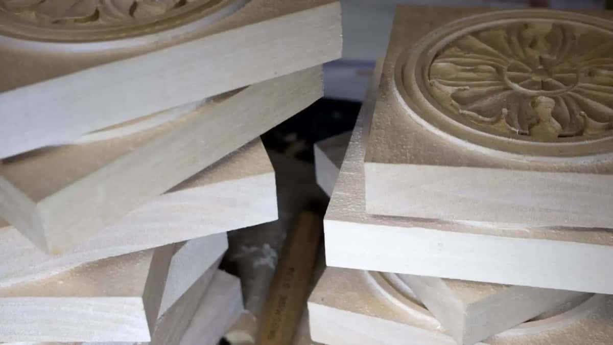 Stack of sawn basswood blanks beside a finished rosette