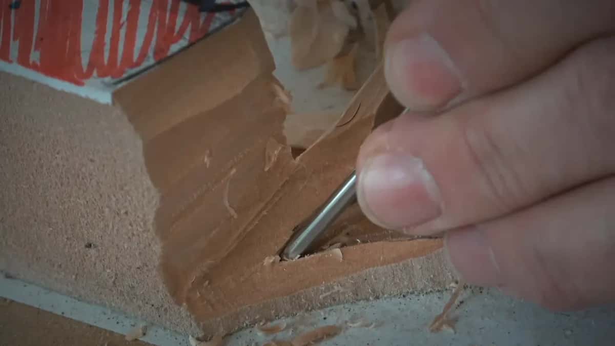 How dry stock behaves Small gouge lifting one clean curl from seasoned basswood, tight corner
