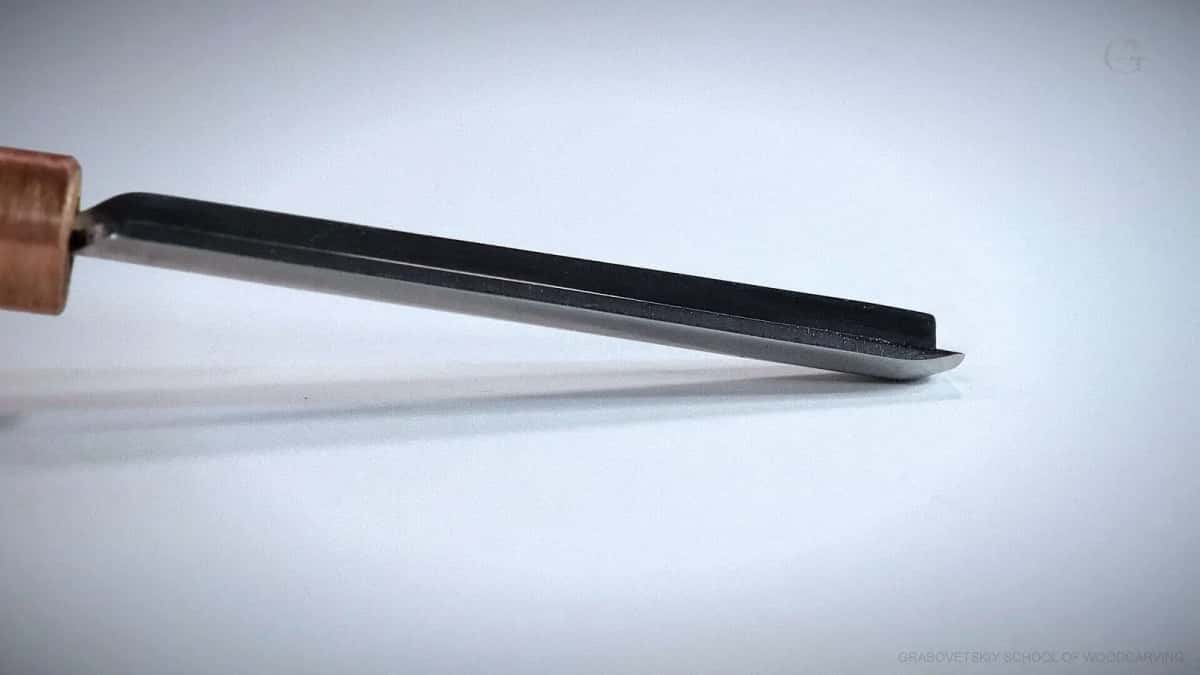 A chisel seen edge on, the bevel honed until the line disappears