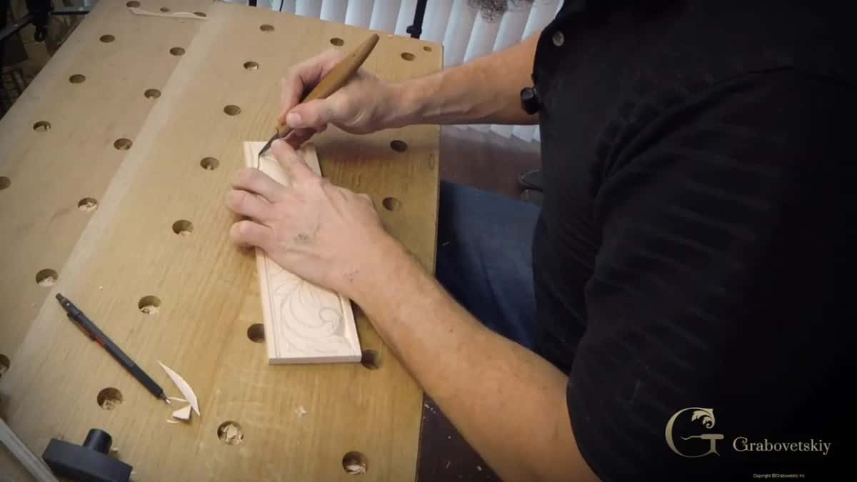 Both hands on a carving strip with the steadying hand kept well behind the blade for safety