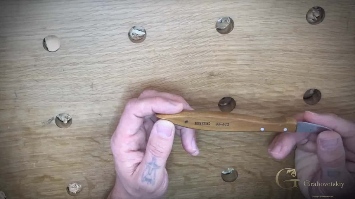The Swiss made number 12 chip carving knife SWISS MADE and a small arrow stamped into the pale handle of a Pfeil carving knife