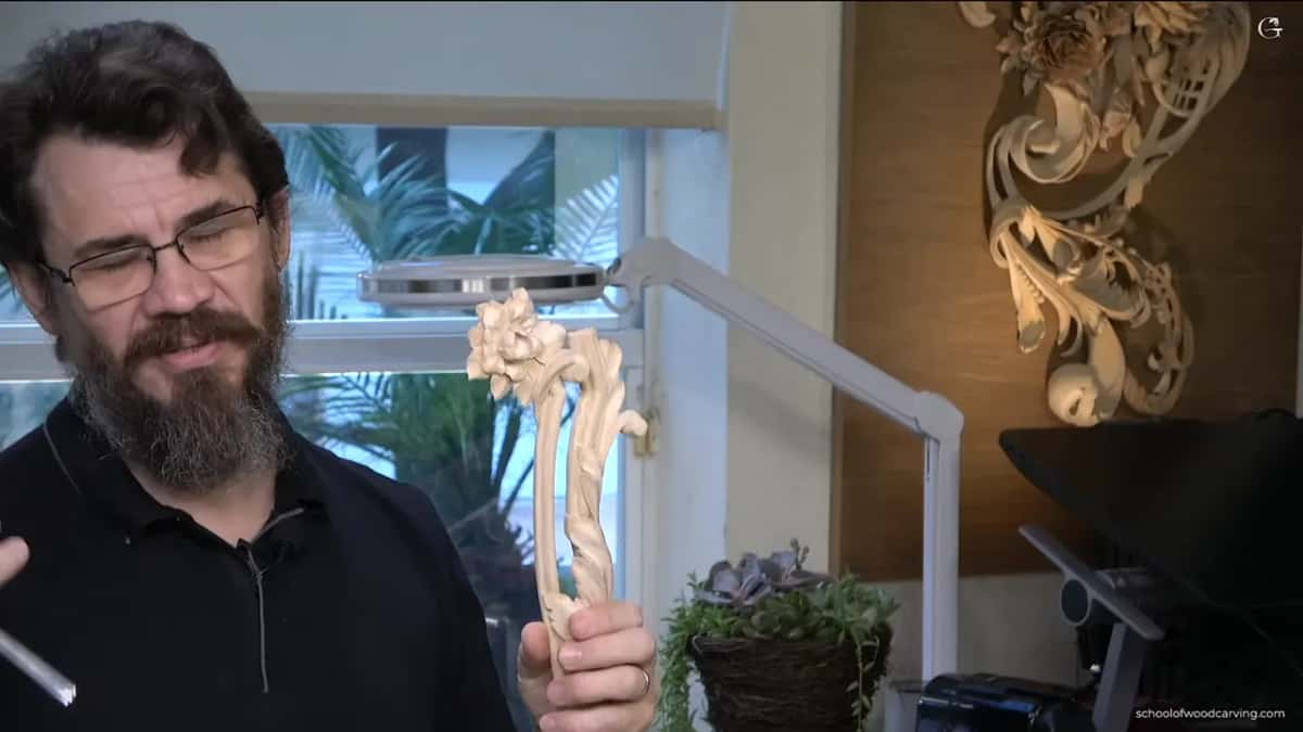 Holding one finished piece up, a flower on top and the leaf running down across molding