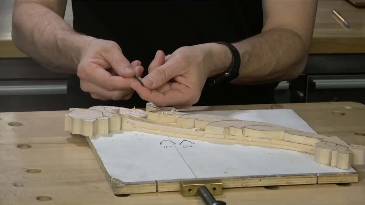 Profiles of a number 11 and a number 17 drawn by hand on the paper under the blank