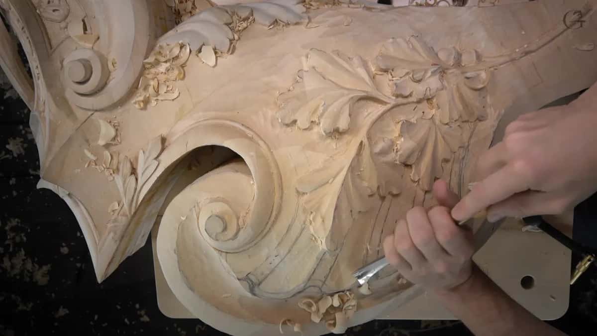 Overhead again, both hands start the shell on the lower curve, scrolls at the top left and the leaves above