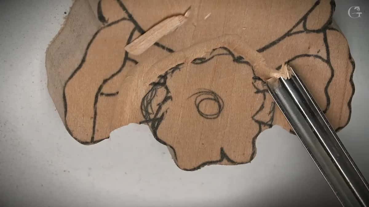 Chip rising where the blade meets the pencil line, the rest of the drawing still untouched wood