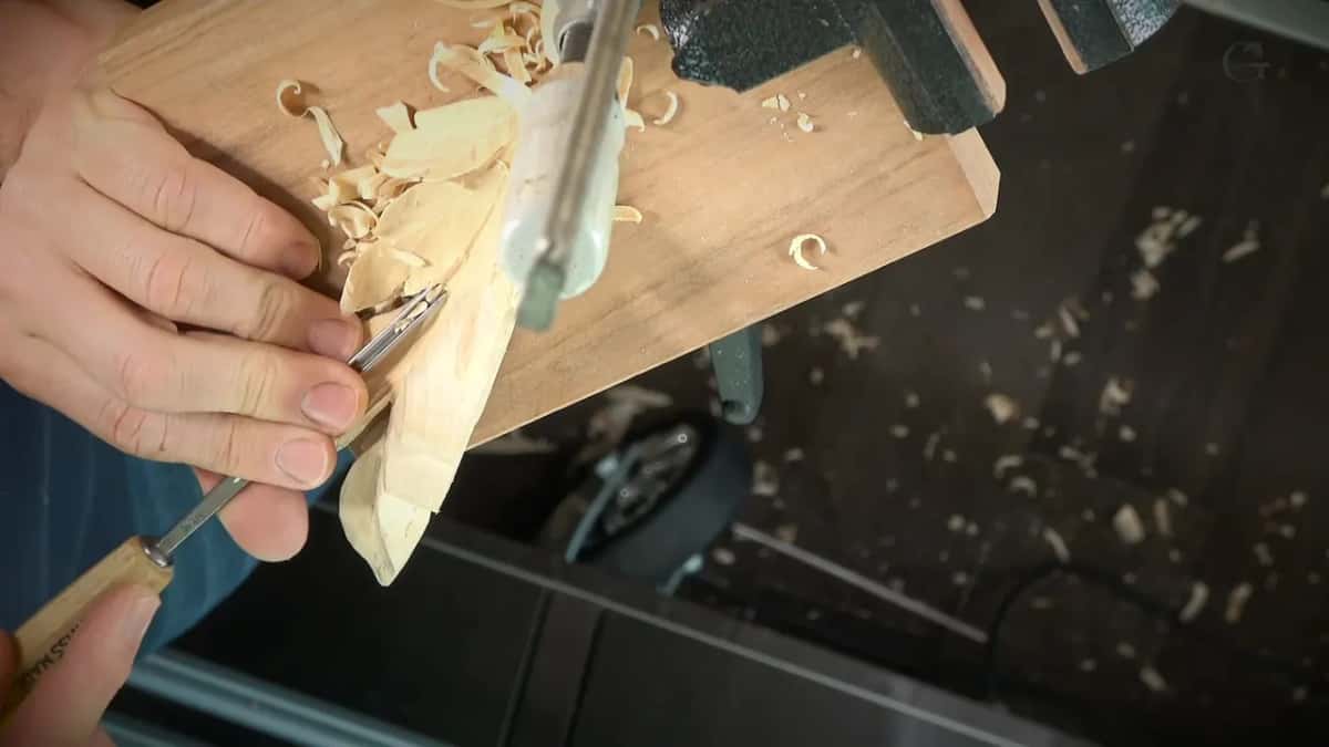 Swiss Made stamped along the handle in his left hand