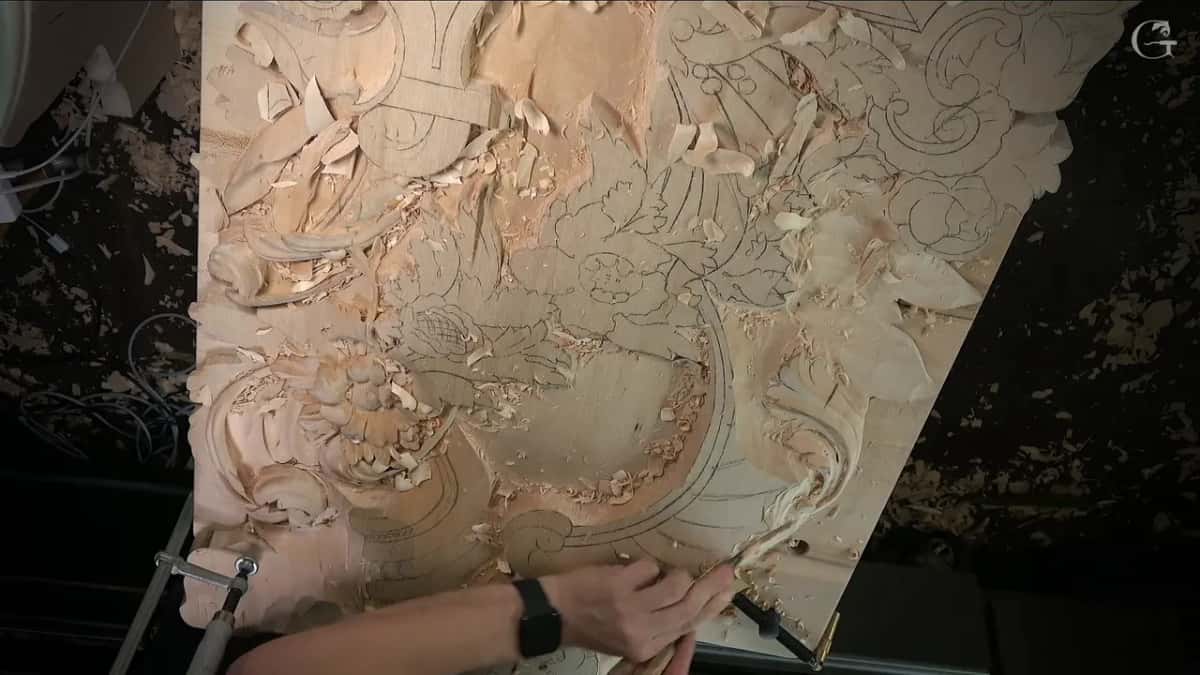 Hand and tool near the lower corner of the full panel