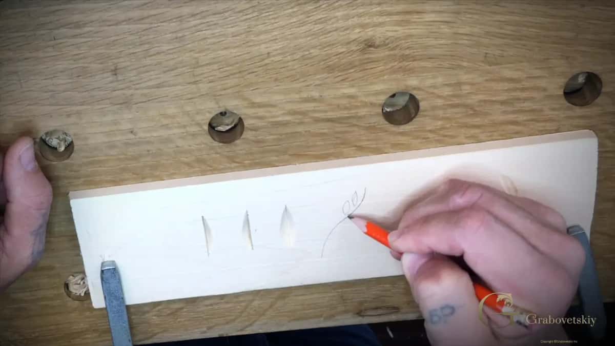 Drawing freehand in pencil beside the finished chip cuts