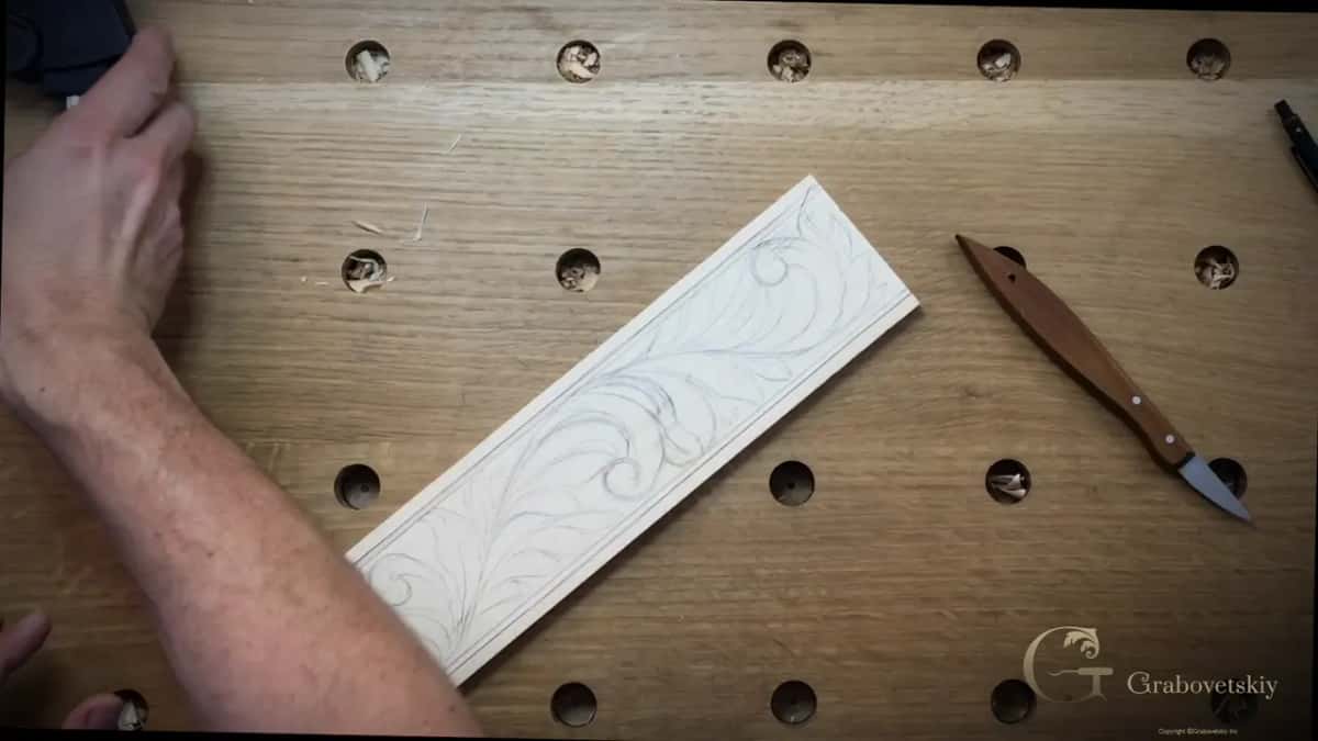 Drawn design and the knife alongside it on the bench top