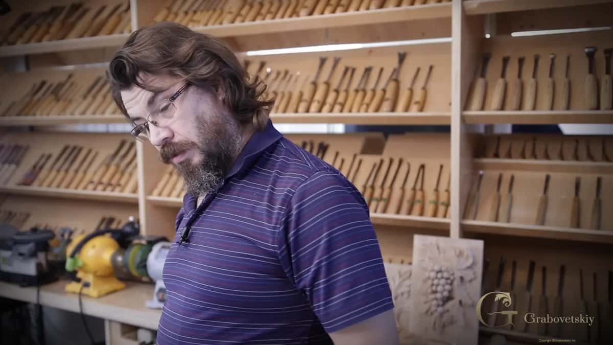 Alexander at his bench, taking stock of how the panel is coming along.