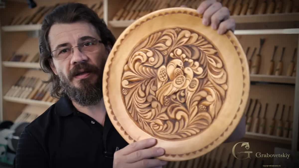 A dish I carved about twenty years ago in this same curly style, held up beside the tool rack.
