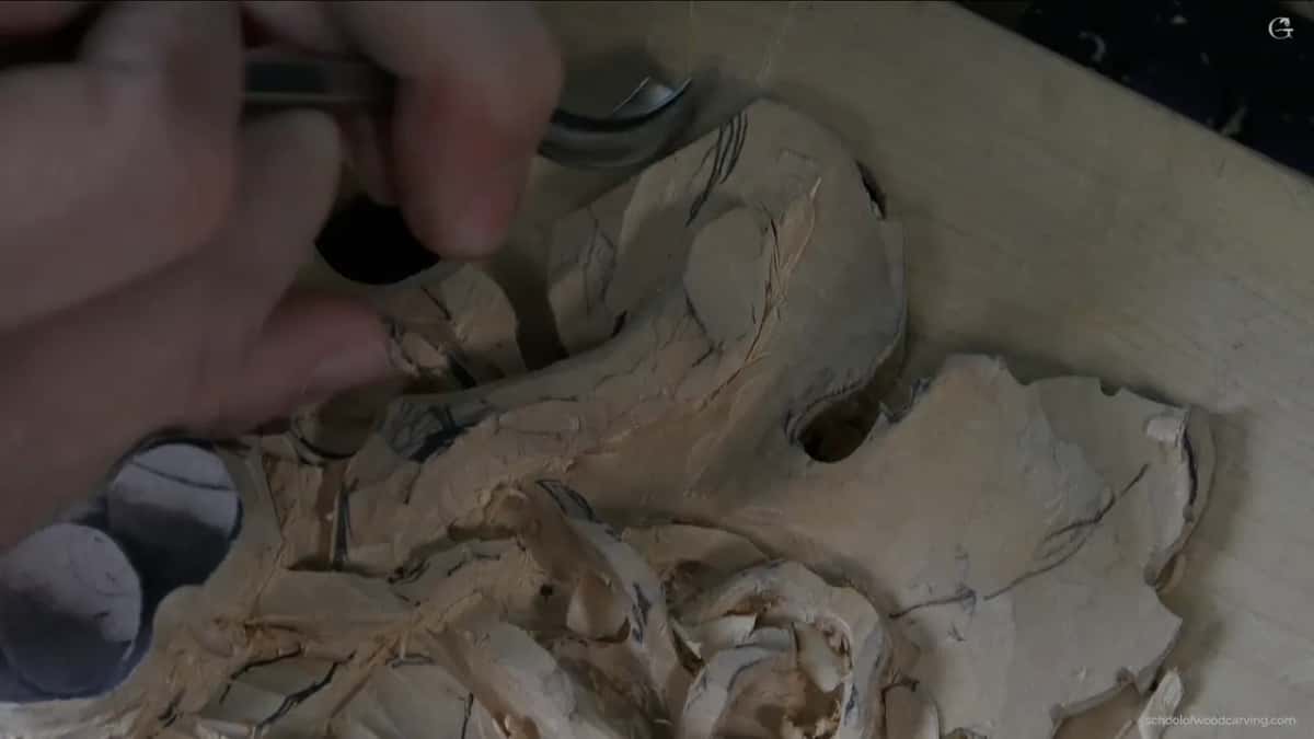 Bent gouge working outward from inside the hollow, because coming the other way the edge catches and lifts fibres
