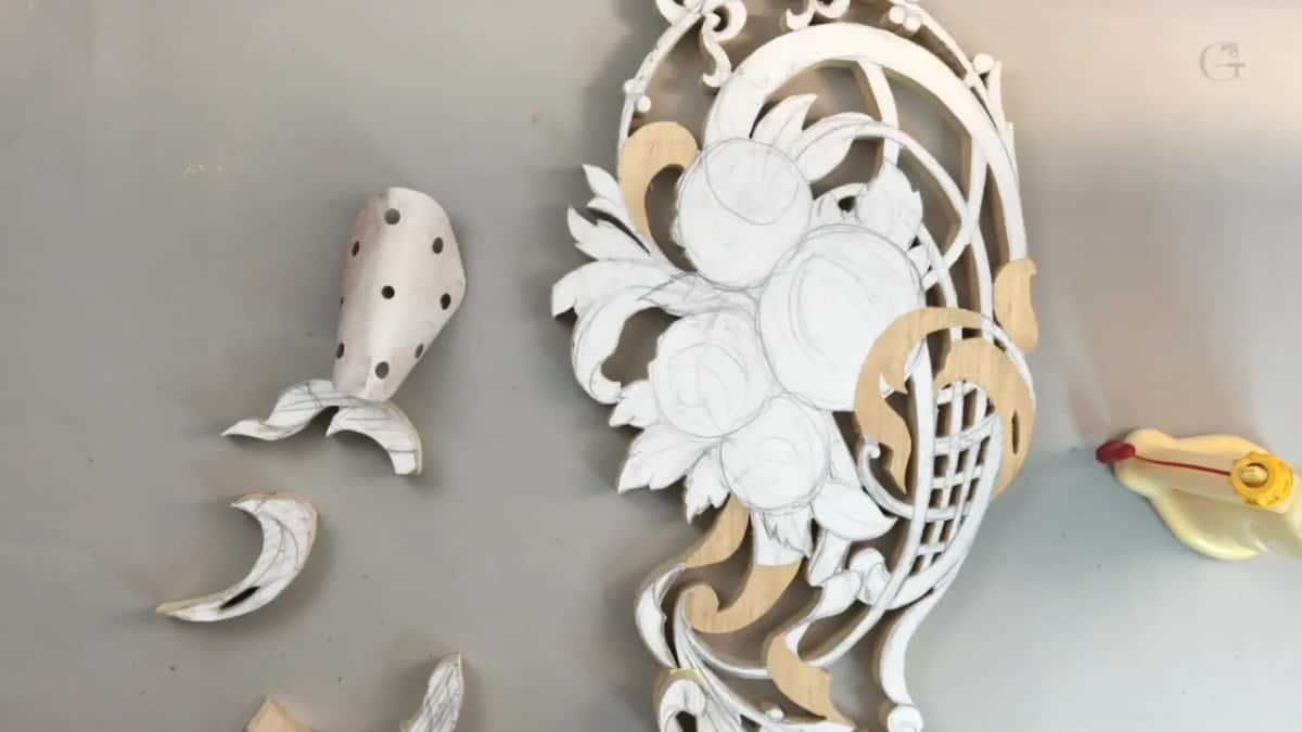 Loose carved pieces lying beside the panel, too small for a layer and right for something else