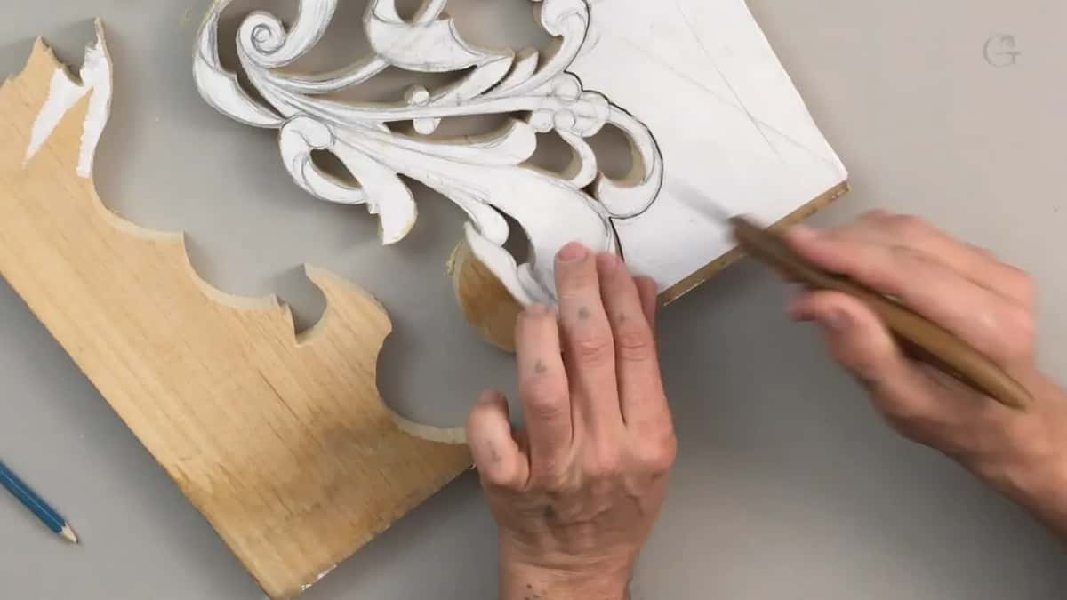 Hands lifting the paper pattern away clean so it can go onto an offcut next