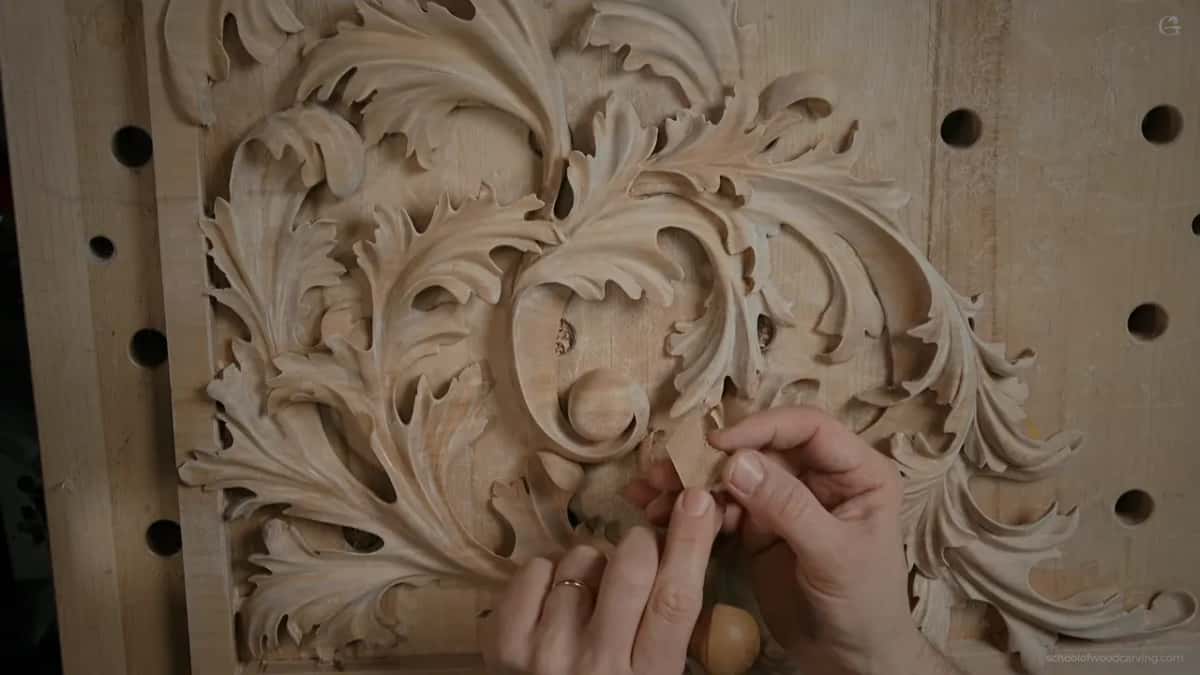 Two hands pressing a pale chip