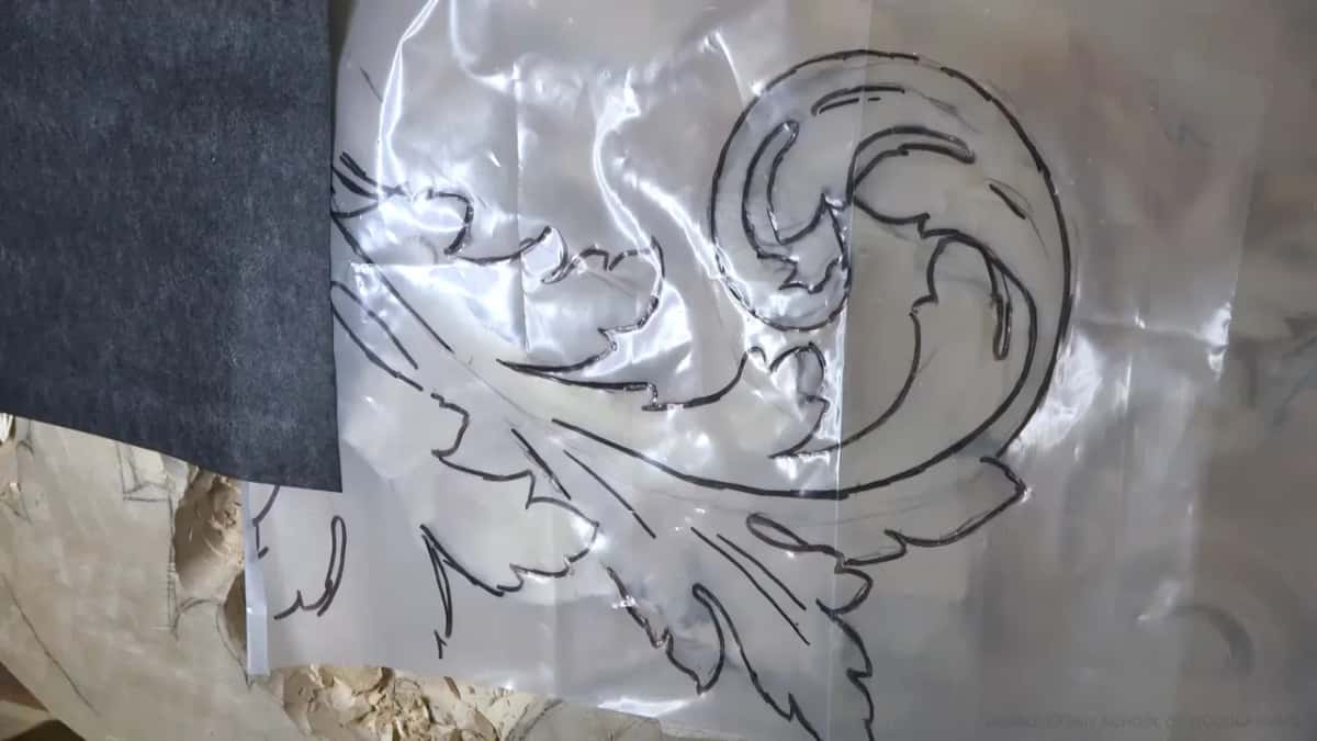 Gray carbon paper going in below the plastic at its left edge.