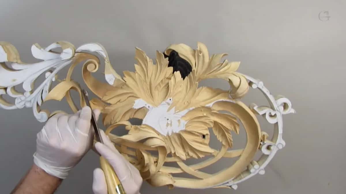 Gloved hand, tool in, bare forearm above.