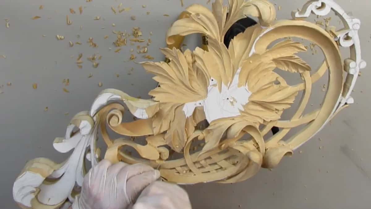 Two gloved hands low on the panel, just under the lattice