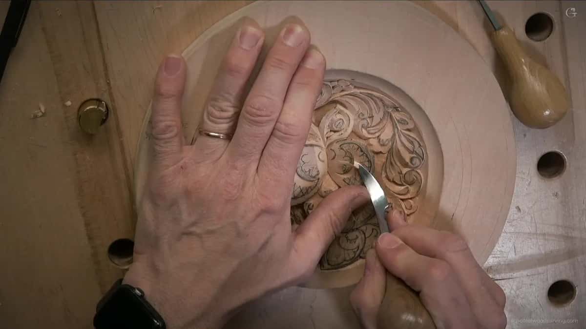 Fingers spread across the plate, blade near the upper right