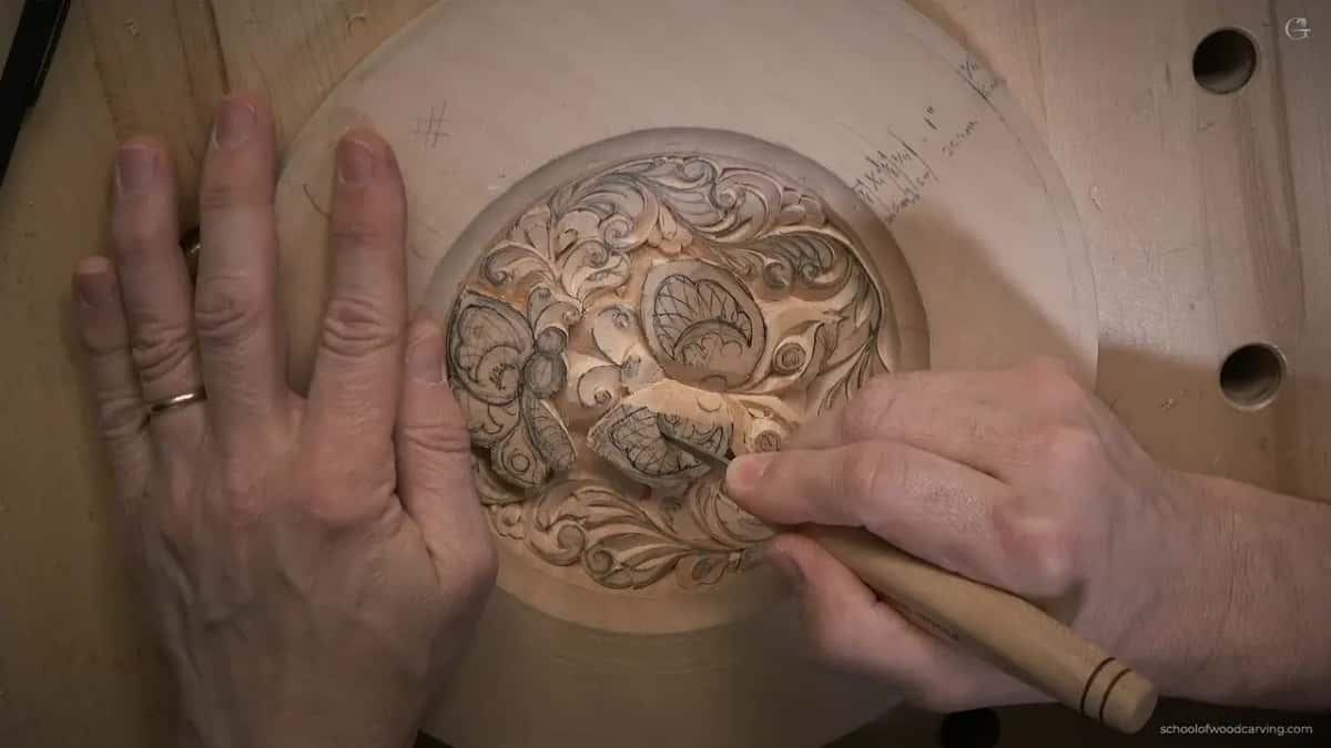 Left hand pins the rim while the knife rides low along a wing