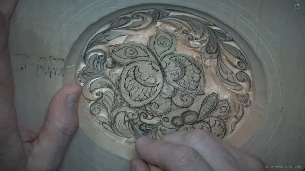 Rows of carved curls fill the left side while the butterflies still carry only pencil lines