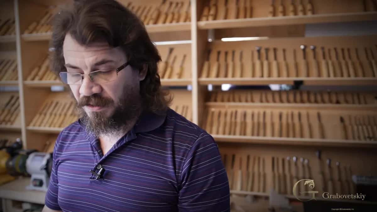 Shelves of gouges filling the whole wall behind him.