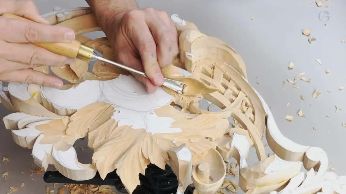 One hand on a bent tool at the lattice, the other on the leaves