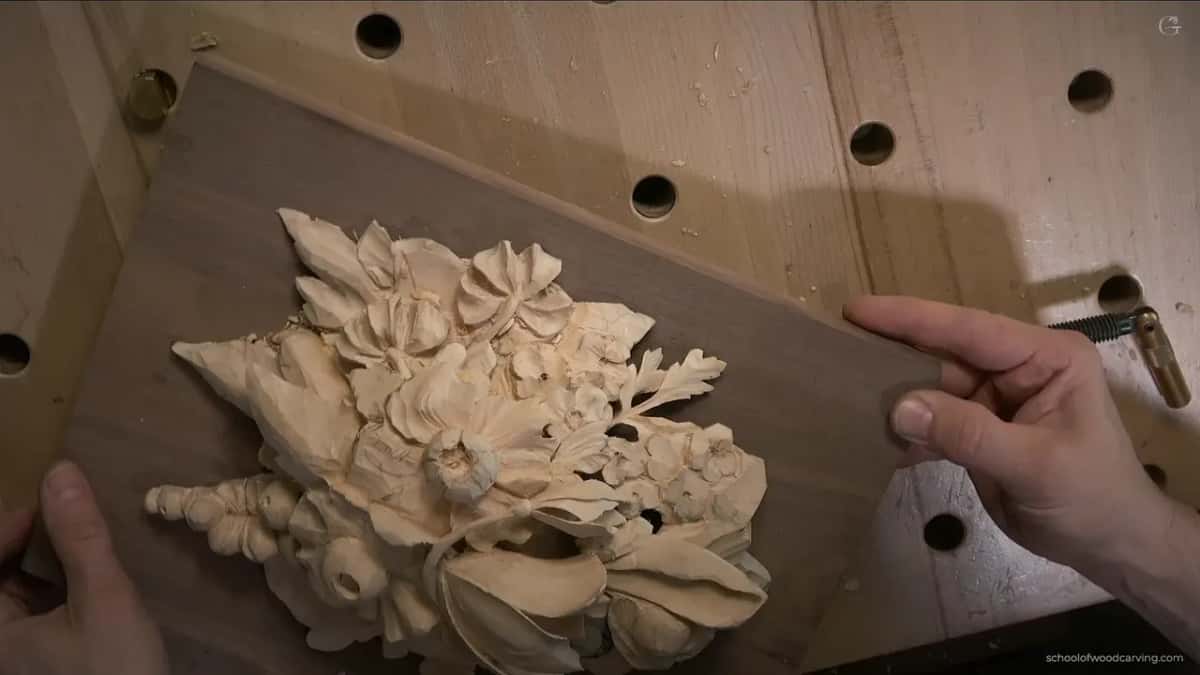 Parsley leaf and flowers on the Grinling Gibbons panel, the walnut board lifted off the bench and turned toward the light