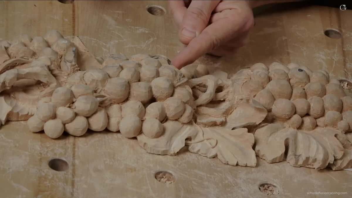 Hand coming in from the top right, the bunch of grapes and the leaves already roughed out