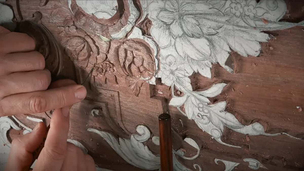 Needle point at the left, a dark handle rising through the frame