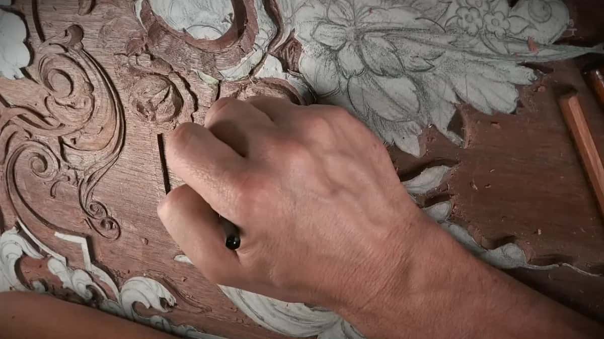 Closed hand on the panel, a ring catching the light