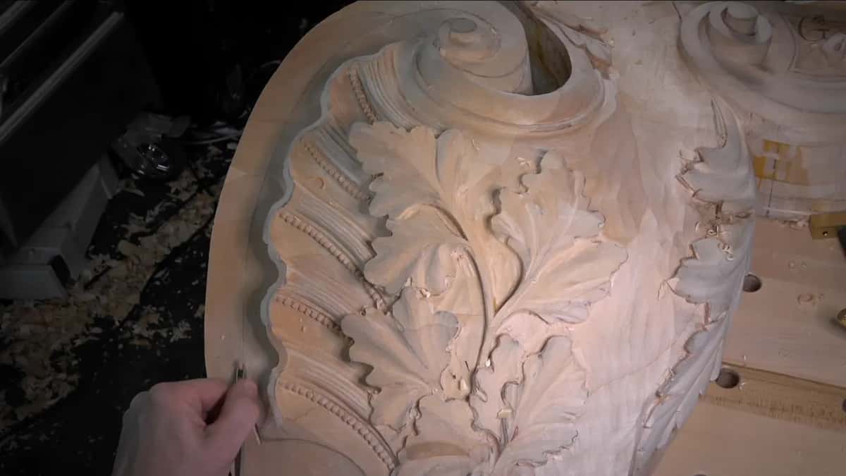 Beaded ribs of the shell sit just inside the outer rim, where a small gouge works the edge line.
