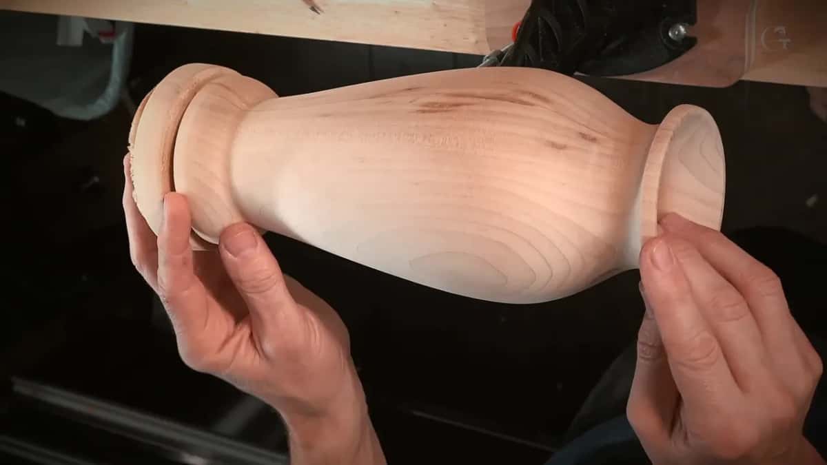 Bare turned vase in two hands