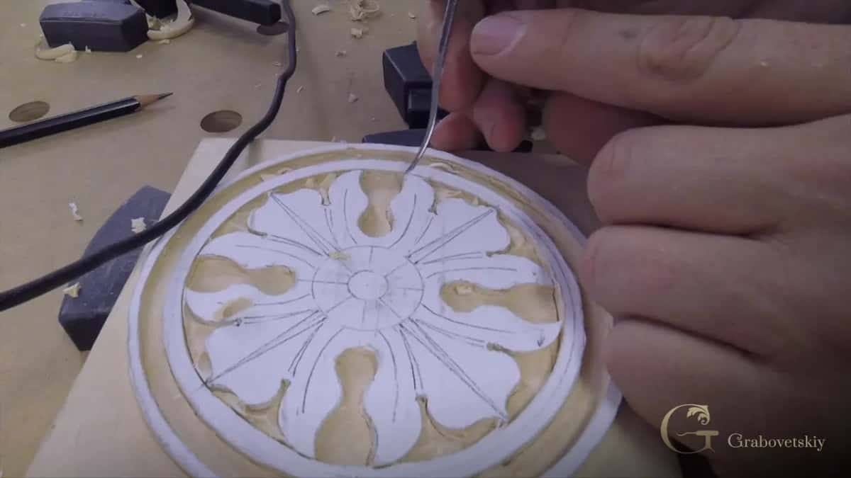 A long thin blade reaching into the middle of the rosette, where an ordinary carving tool has simply run out of ideas