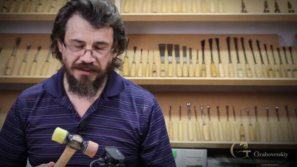 A hand bringing the punch down onto open ground, which is where the texture is easiest to start