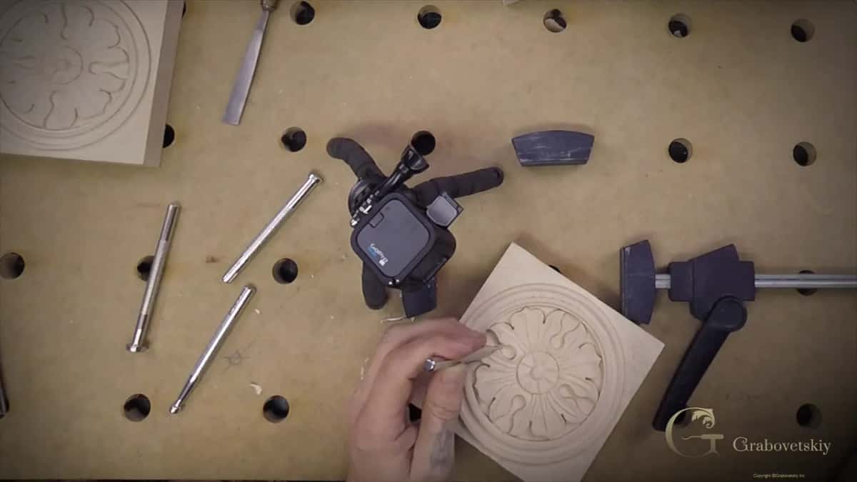 Hand steadying the piece