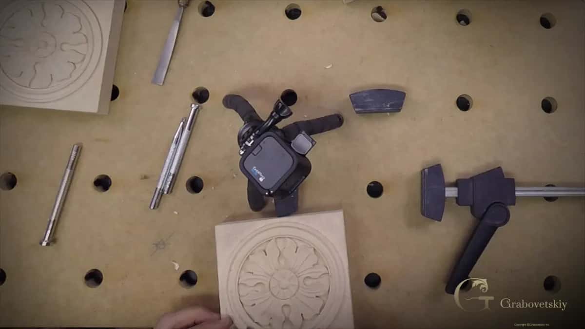 The bench with the rosette clamped and every punch within reach, laid out in the order they get used
