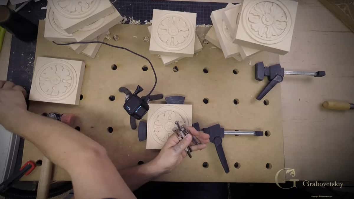 Several finished rosettes lying together on the bench, which is fifteen pieces of work nearly done