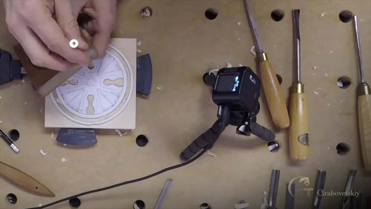 A screw run through scrap so an eighth stands proud, the gauge if you want one