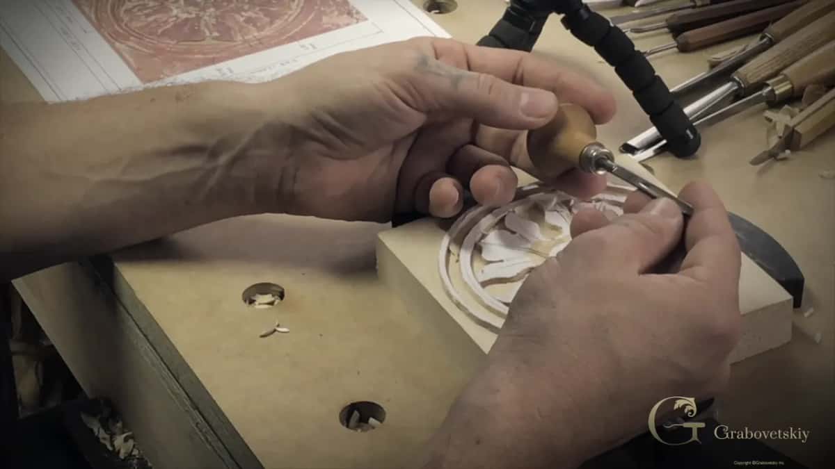 Hand and tool over the piece