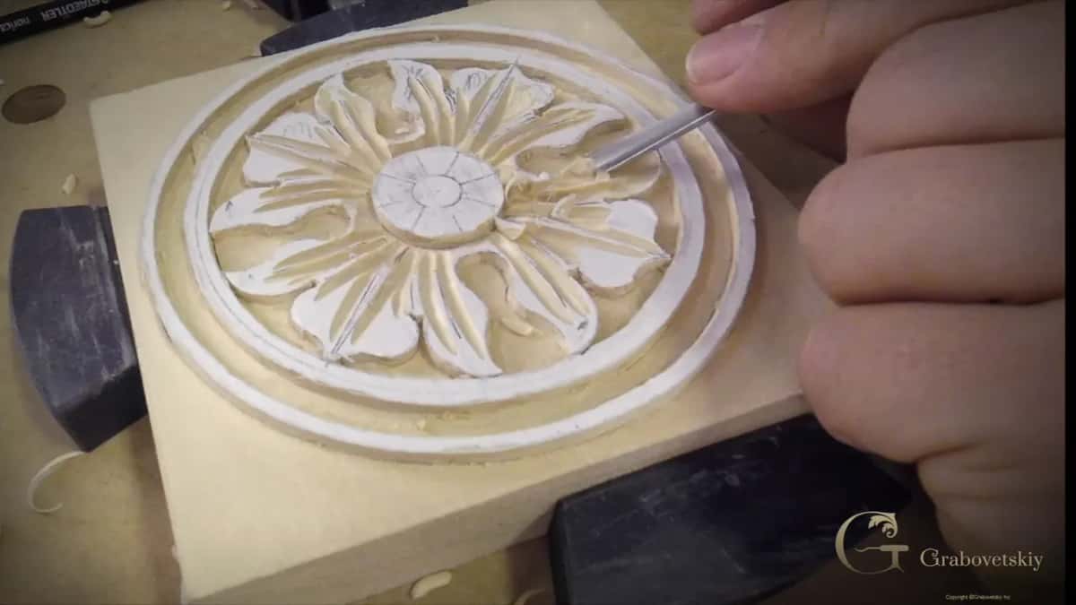 Hands in the middle with the tool travelling outward, since a whole leaf gets shaped from there outward