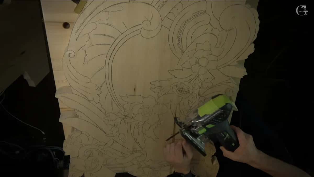Green jigsaw held against the board where the whole design has been traced in pencil