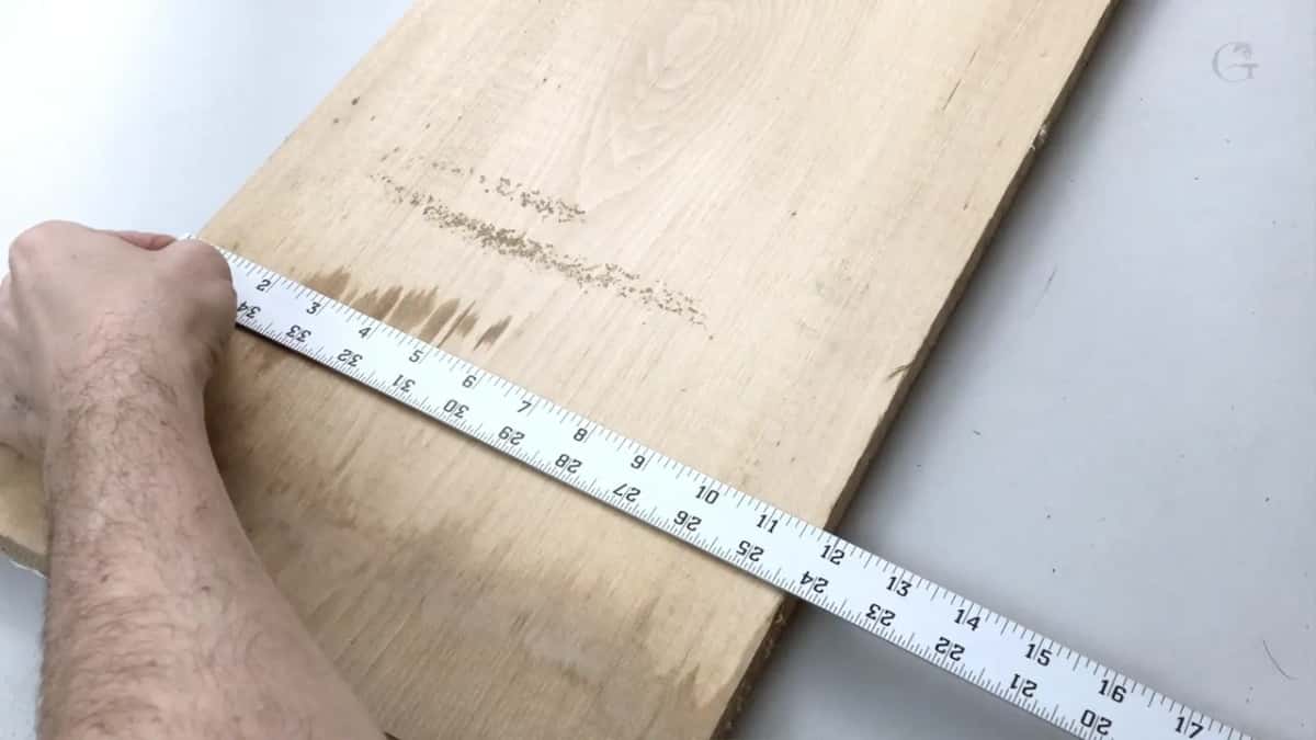 Tape measure laid across the rough board