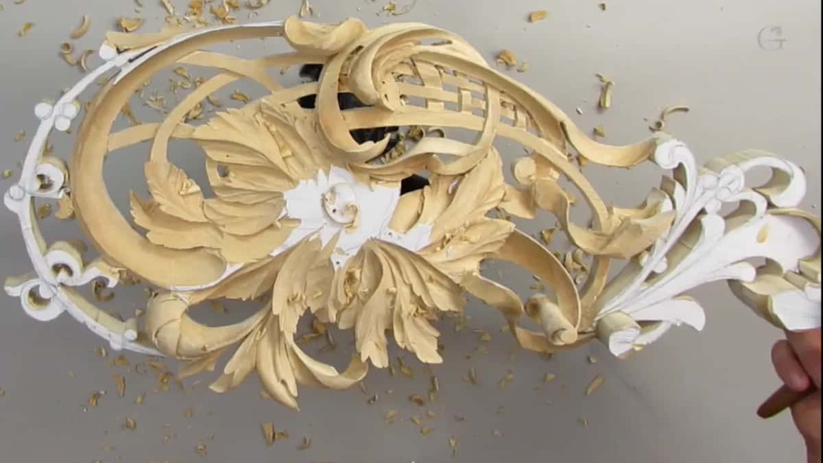 Wide carved ribbons sweeping around the leaves and lattice