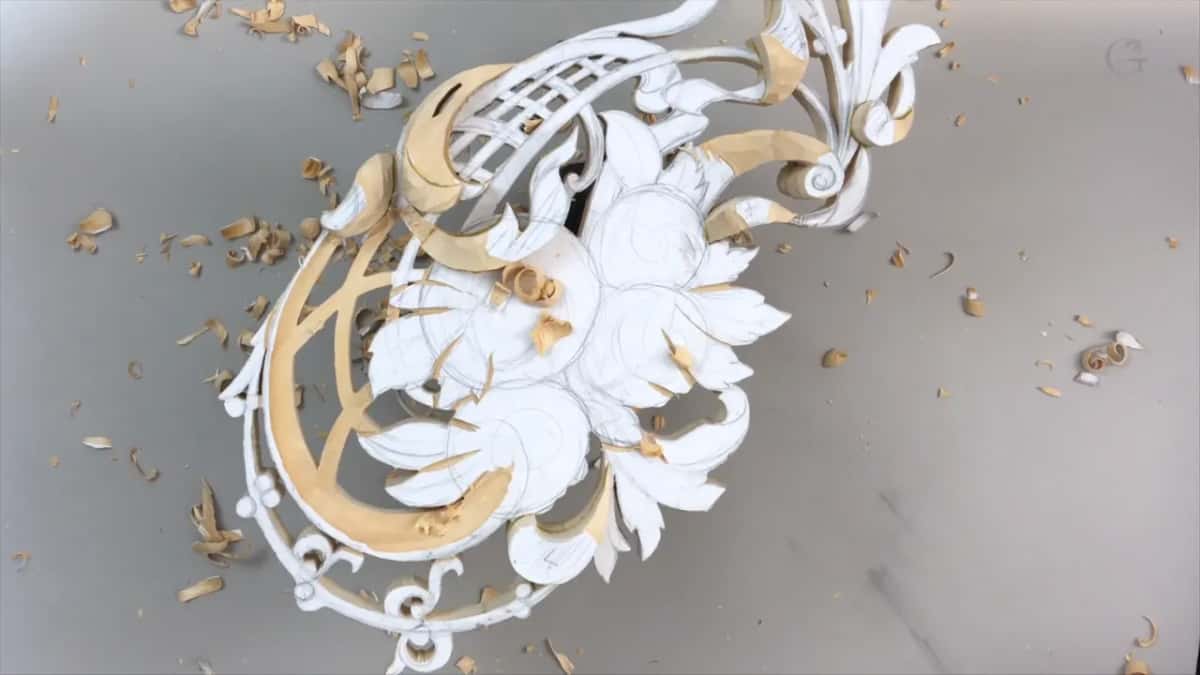 Chips scattered around the panel, some shapes lowered already and others still flat under their paper pattern