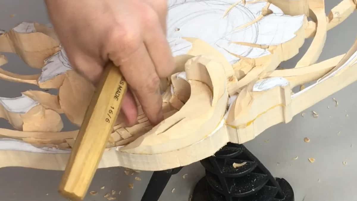My hand gripping the Swiss made V tool, its handle stamped 16 over 6, panel below