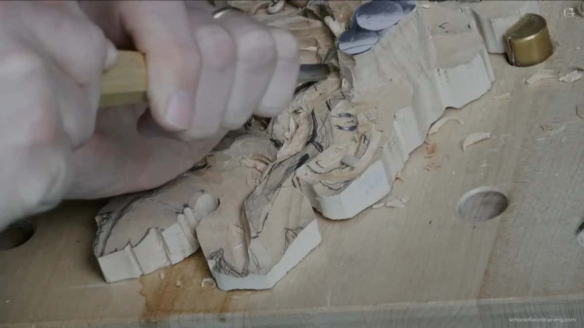 Boxwood handle gripped low in the palm while the arc goes in underneath