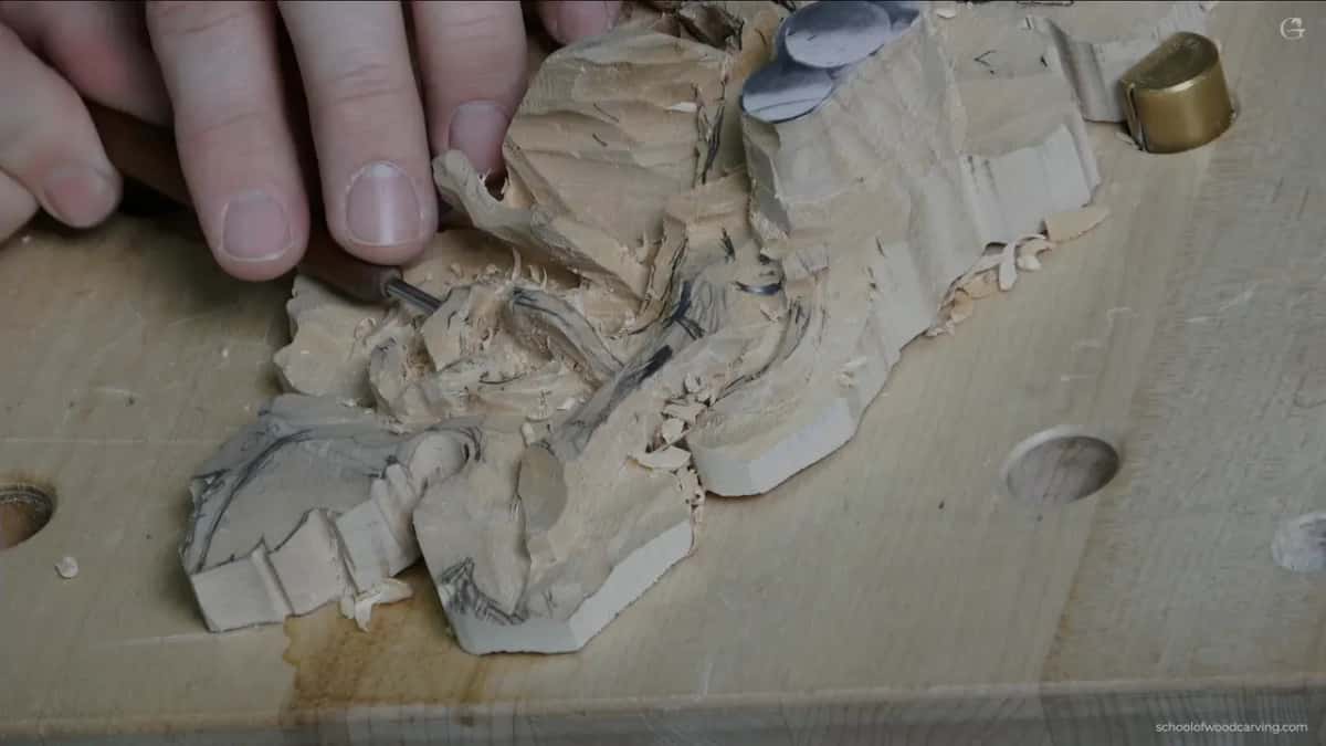 Thumb and finger beside the freed curl
