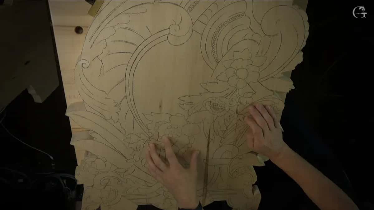 Both hands rest on the sawn board, its whole pattern still in pencil and not one groove in it yet